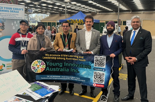 A group of people holding a banner
Description automatically generated