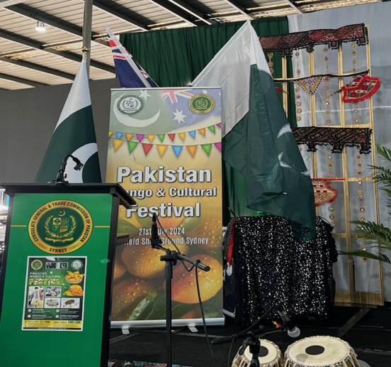 A stage with flags and a sign
Description automatically generated