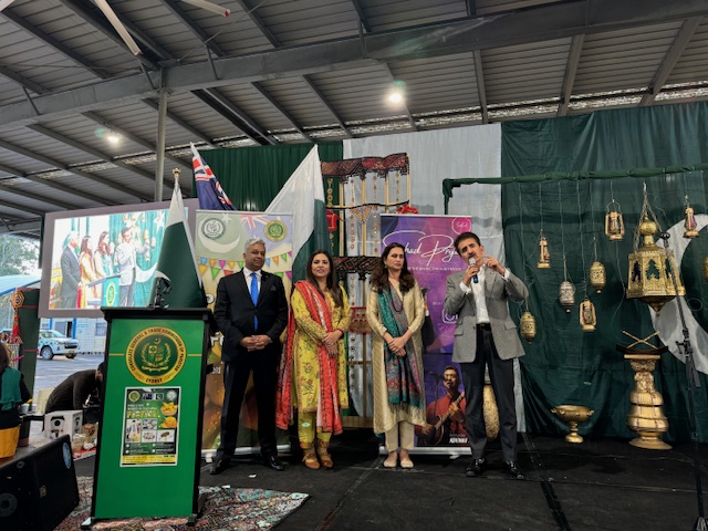A group of people standing on a stage
Description automatically generated