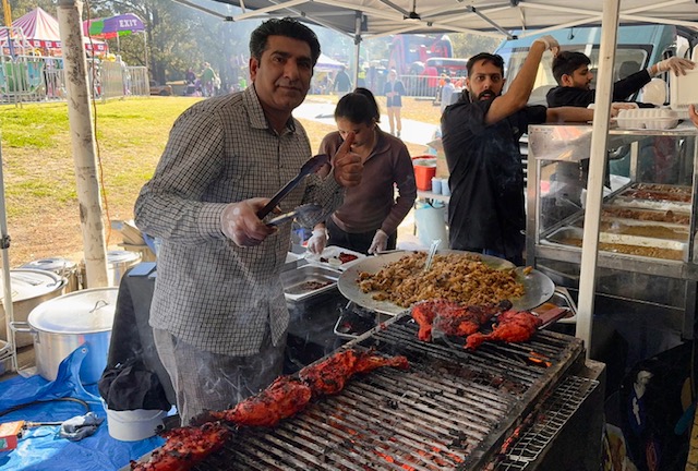 A group of people cooking food
Description automatically generated