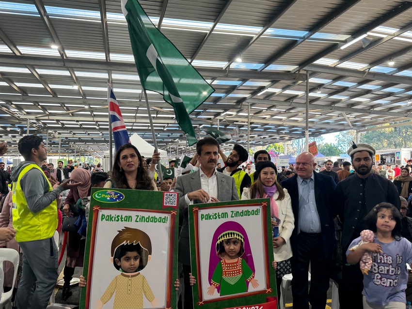 A group of people holding signs
Description automatically generated