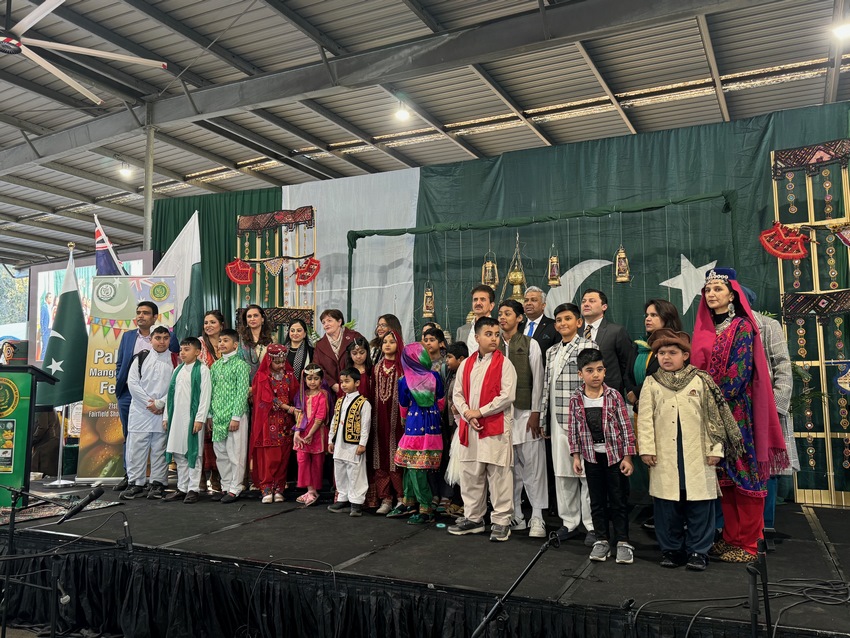 A group of people standing on a stage
Description automatically generated