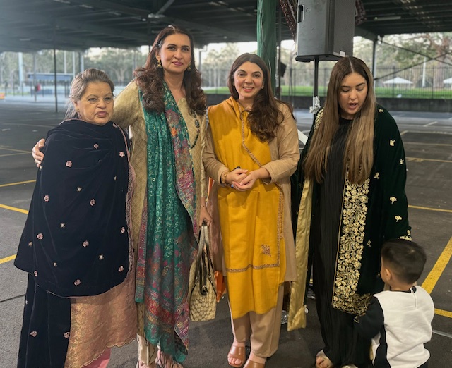 A group of women standing together
Description automatically generated