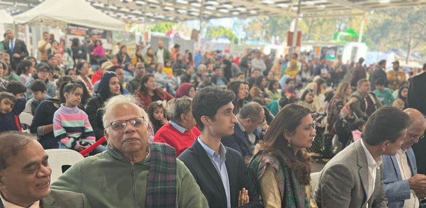 A group of people standing in a crowd
Description automatically generated