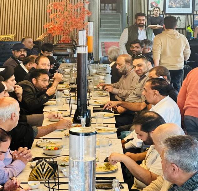 A group of people sitting at a table eating
Description automatically generated