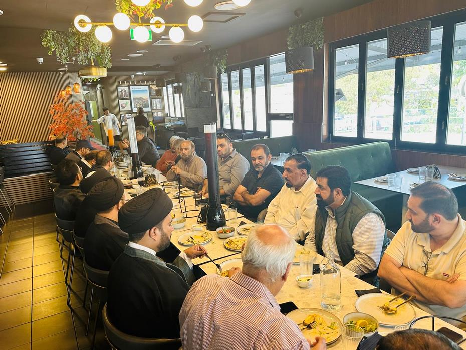 A group of people sitting at a table
Description automatically generated