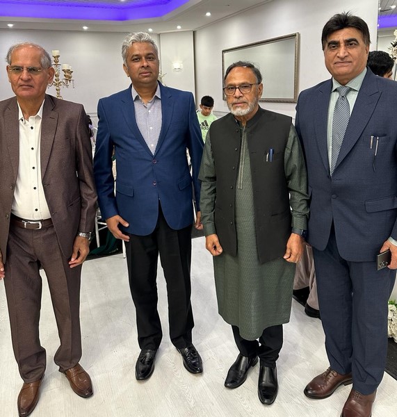 A group of men standing together
Description automatically generated