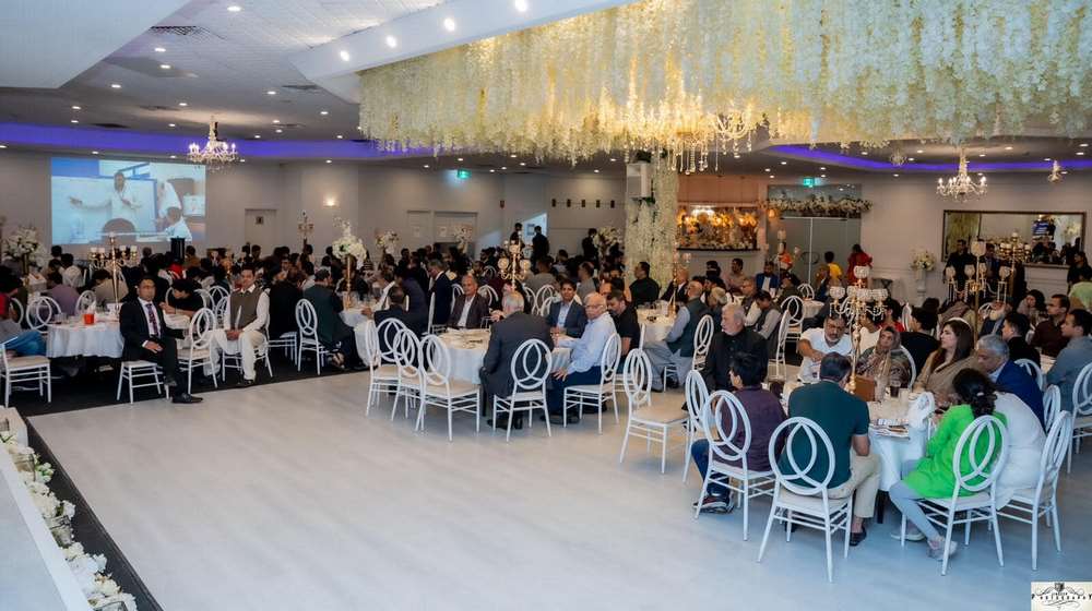 A group of people sitting at tables in a room
Description automatically generated