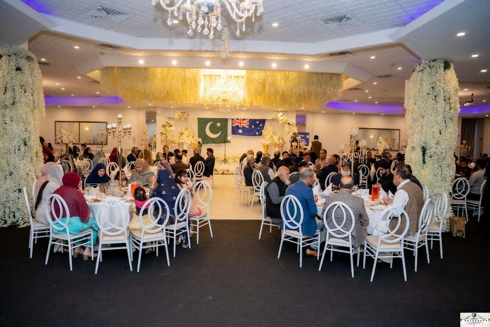 A group of people sitting at tables in a room
Description automatically generated