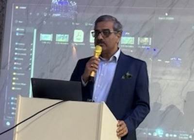 A person holding a microphone
Description automatically generated