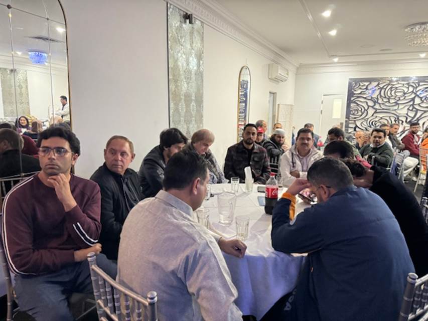 A group of people sitting around a table
Description automatically generated