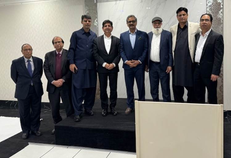 A group of men standing on a black platform
Description automatically generated