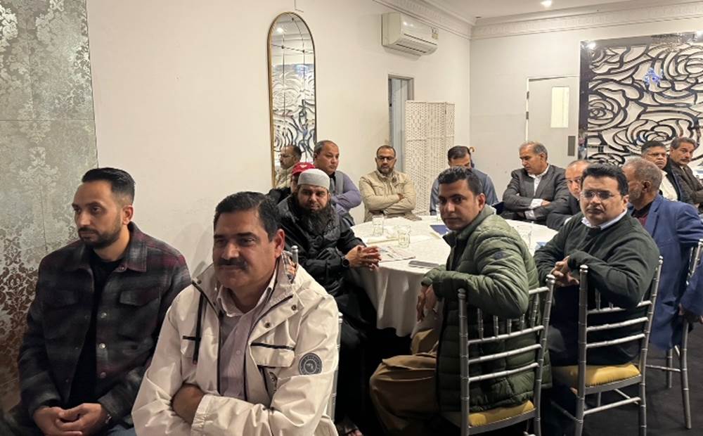 A group of men sitting at a table
Description automatically generated
