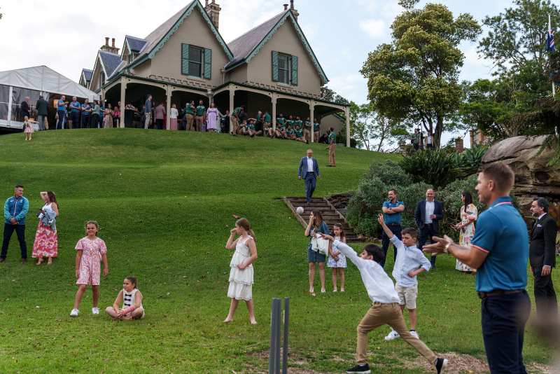A group of people playing ball in a grassy field

Description automatically generated