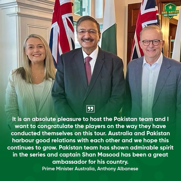 A group of people standing in front of flags

Description automatically generated