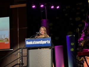 A person speaking into a microphone
Description automatically generated
