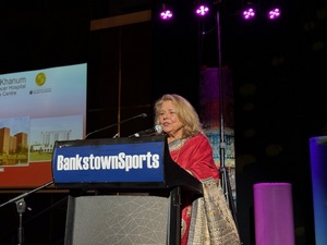 A person speaking at a podium
Description automatically generated