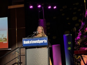 A person speaking into a microphone
Description automatically generated