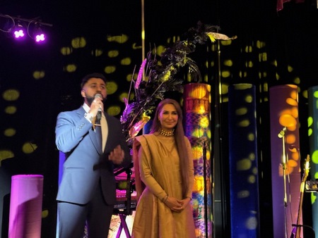 A person and person on stage
Description automatically generated