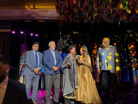 A group of people on a stage
Description automatically generated