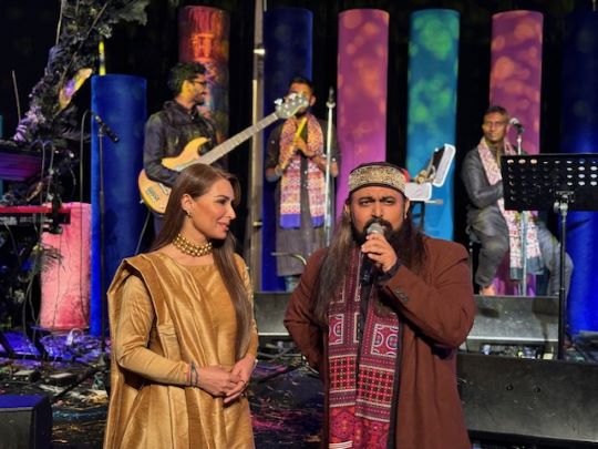 A person and person singing on stage
Description automatically generated