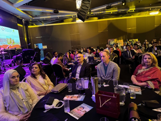 A group of people sitting at a table
Description automatically generated