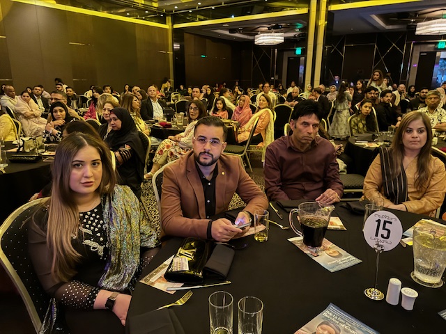 A group of people sitting at tables
Description automatically generated