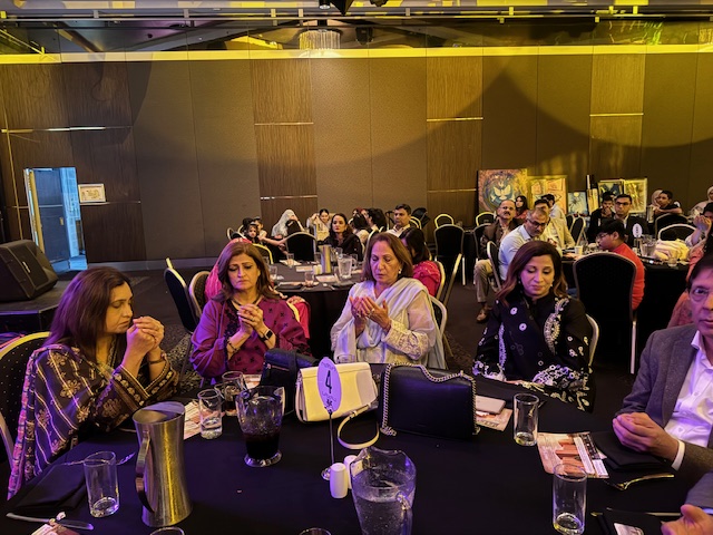 A group of people sitting at a table
Description automatically generated