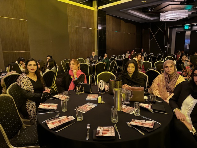A group of women sitting at a round table
Description automatically generated