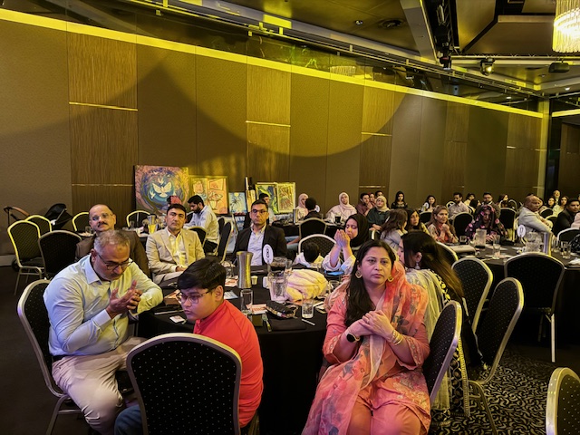 A group of people sitting at tables
Description automatically generated