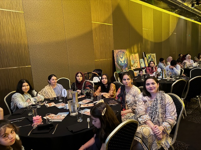 A group of women sitting at a table
Description automatically generated