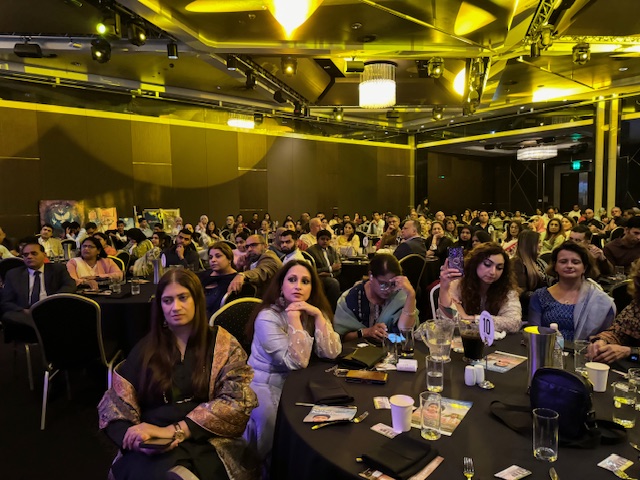 A group of people sitting at a table
Description automatically generated