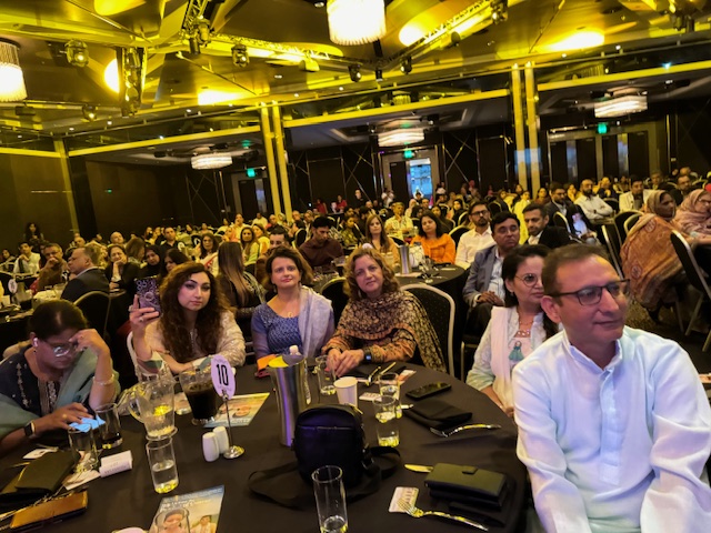 A group of people sitting at a table
Description automatically generated