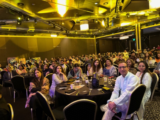 A group of people sitting at tables
Description automatically generated