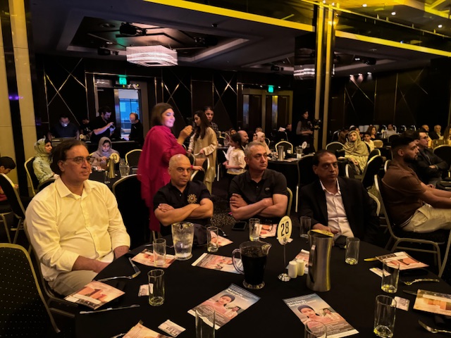 A group of people sitting at a table
Description automatically generated