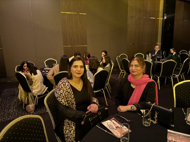 A group of women sitting at a table
Description automatically generated