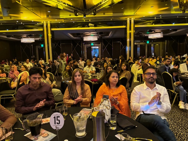 A group of people sitting at tables
Description automatically generated
