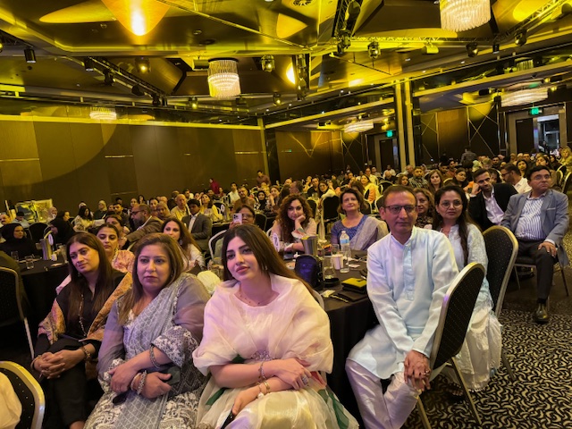 A group of people sitting in a room
Description automatically generated