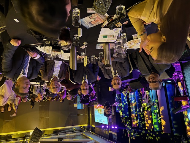 A group of people sitting at a table
Description automatically generated