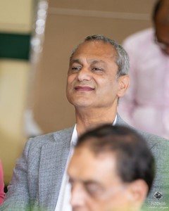 A person in a grey suit

Description automatically generated