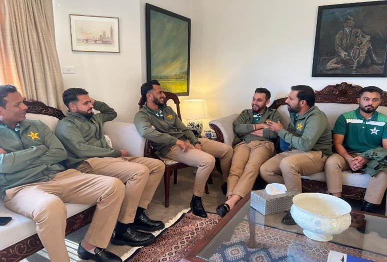 A group of men sitting in chairs

Description automatically generated