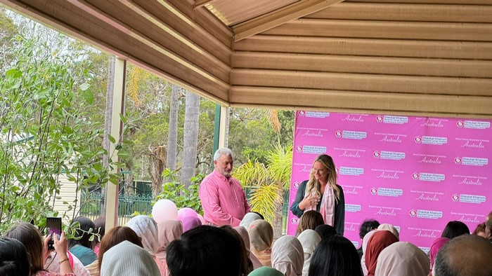 A person and person standing in front of a crowd

Description automatically generated
